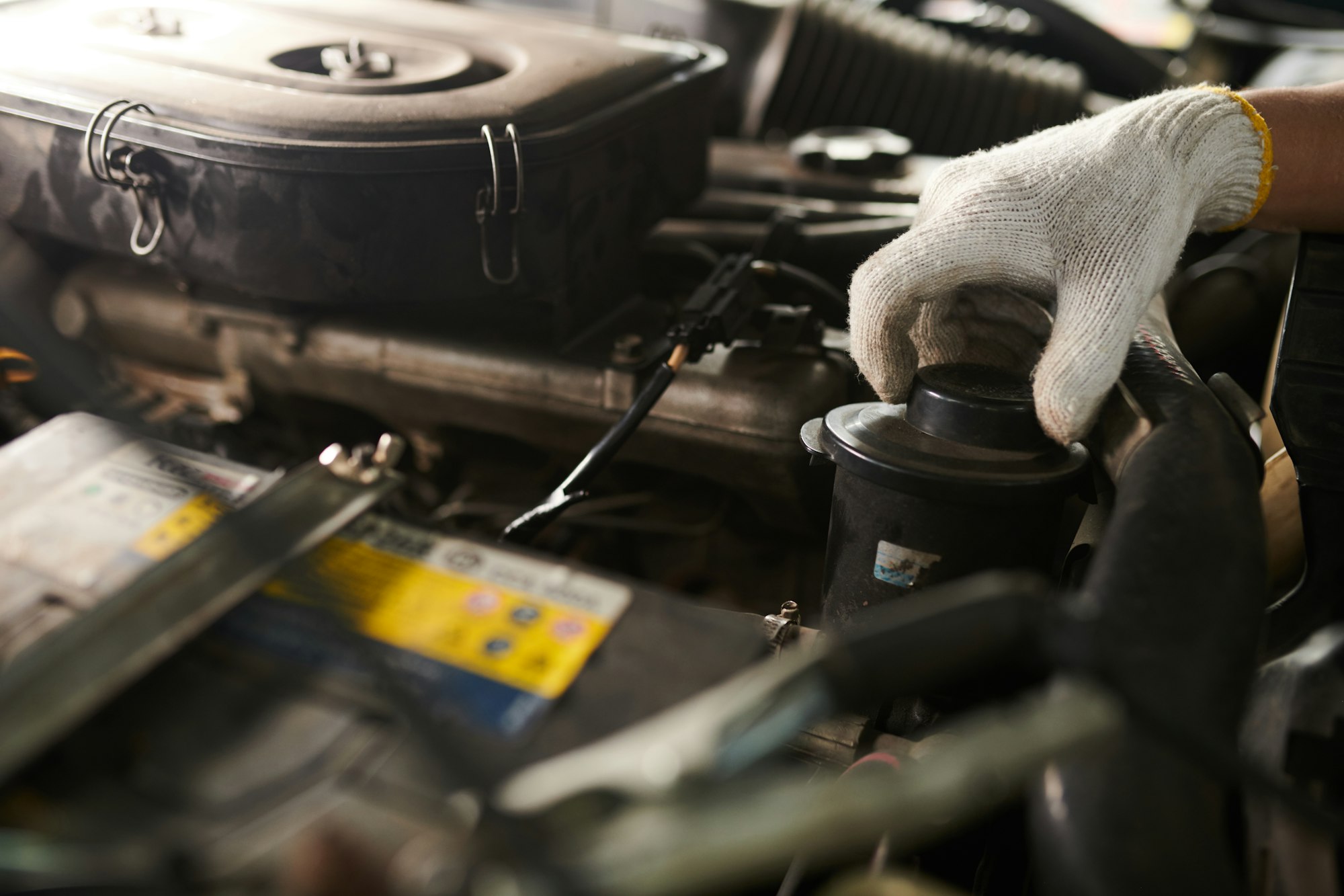 Mechanic Changing Oil in Car